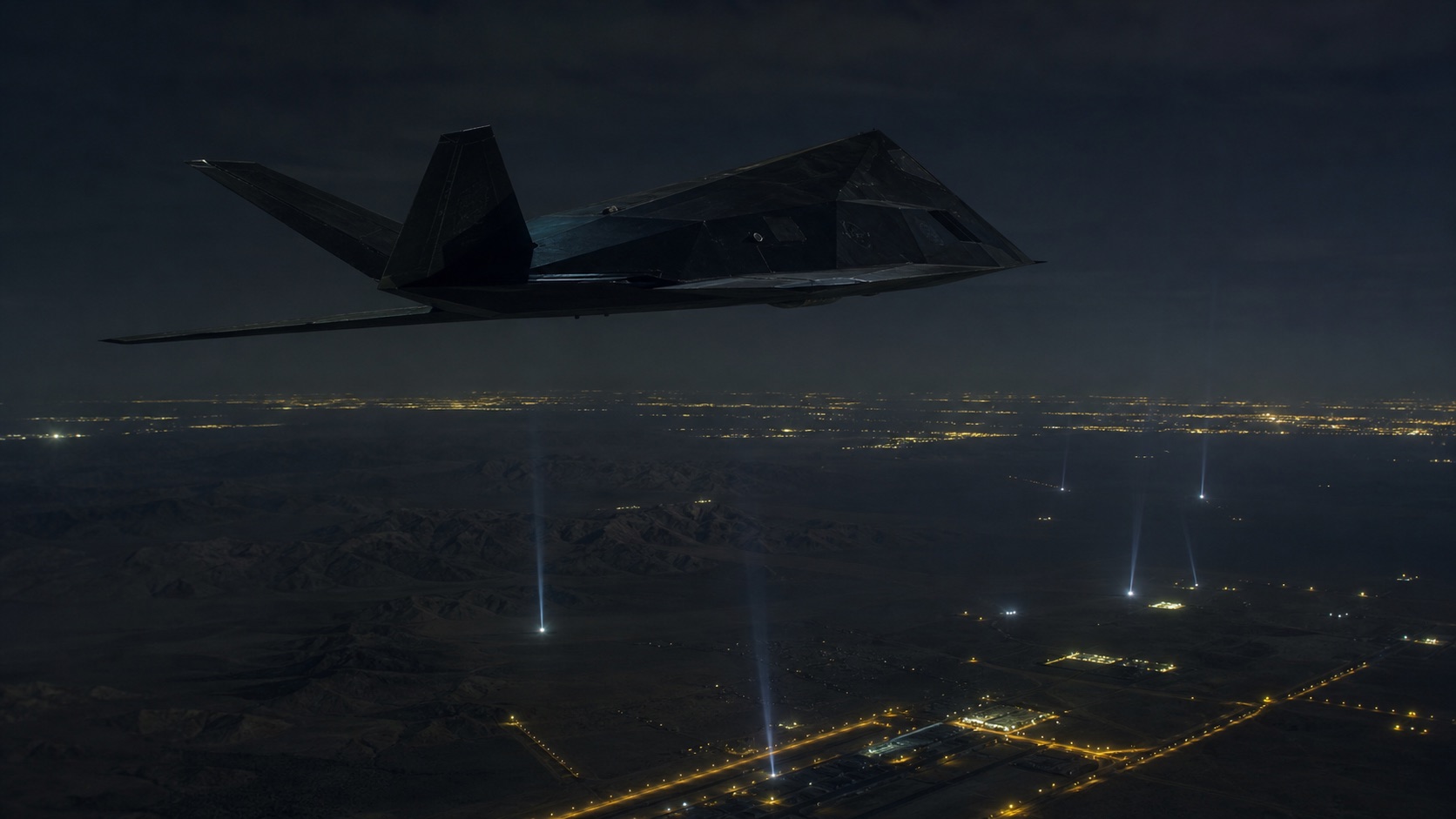 夜間の砂漠都市へ進入するF-117級ステルス攻撃機