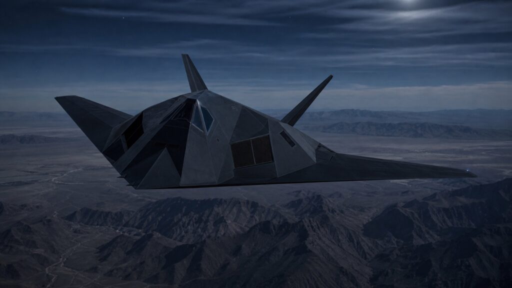 夜間の山岳地帯上空を飛行するF-117級ステルス攻撃機