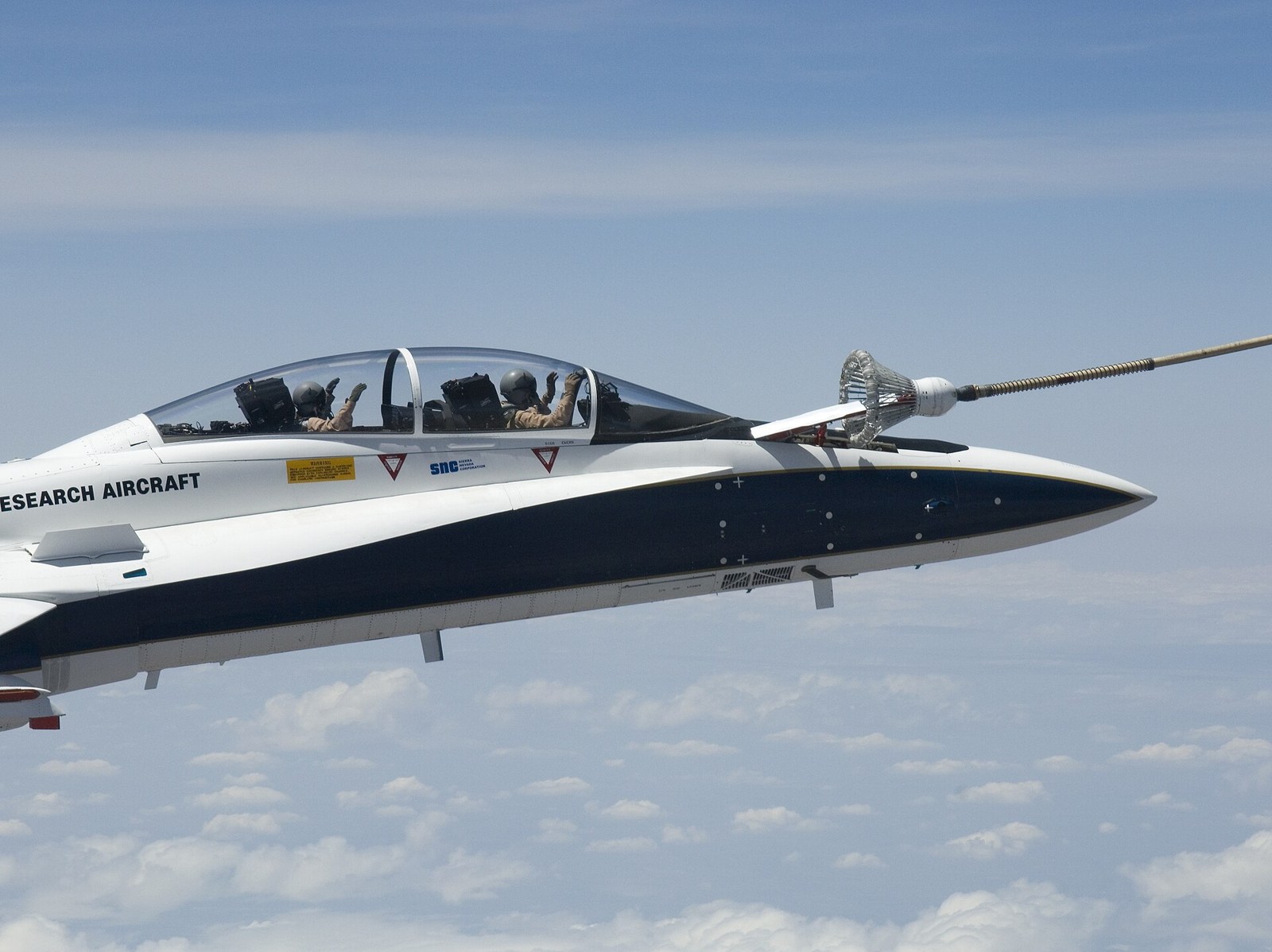 NASAのF/A-18による自動空中給油試験。機首横のプローブをドローグに接続している。